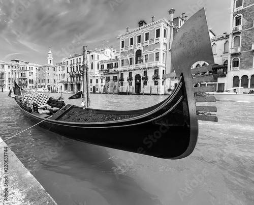 Tourists travel on gondolas at canal Venice, Italy . Gondola trip is the most popular touristic activity in Venice. © afishman64