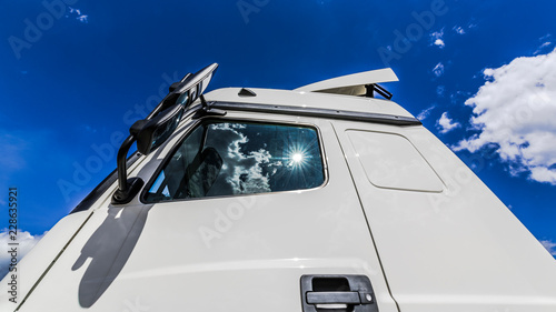 The sun reflected in the glass of the truck