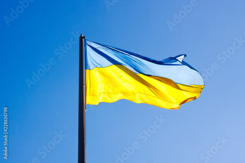 Ukrainian country flag on blue sky background. Sunny.