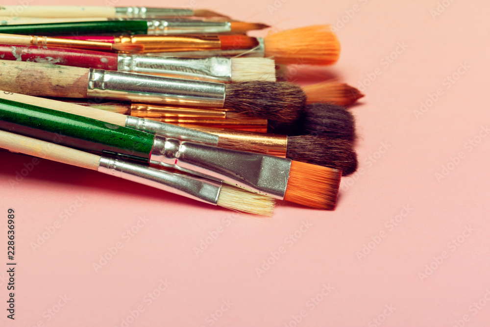 Set of art paint brushes over pastel pink background. Painting supplies,  art concept Stock Photo | Adobe Stock