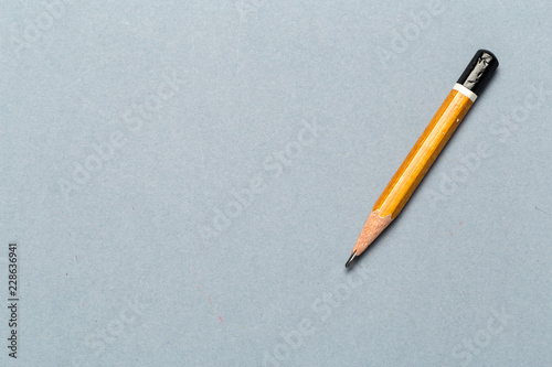 Still life of short worn down  pencil on light gray background
