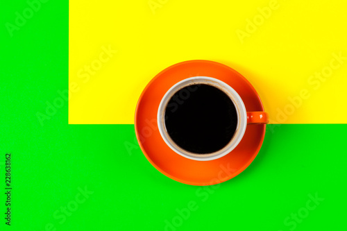 cup of coffee and saucer on color background