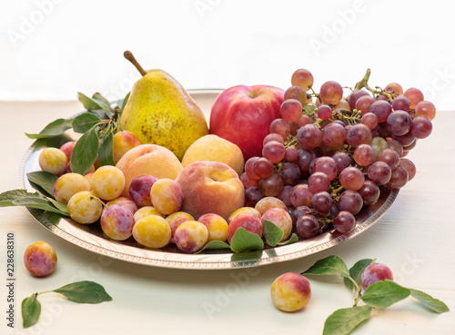 Metal dish with different types of fruits.