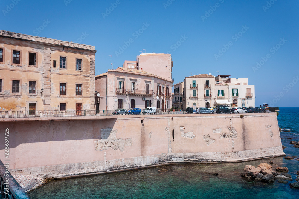 View of old street, facades of ancient buildings in Ortygia (Ortigia) Island, Syracuse, Sicily, Italy