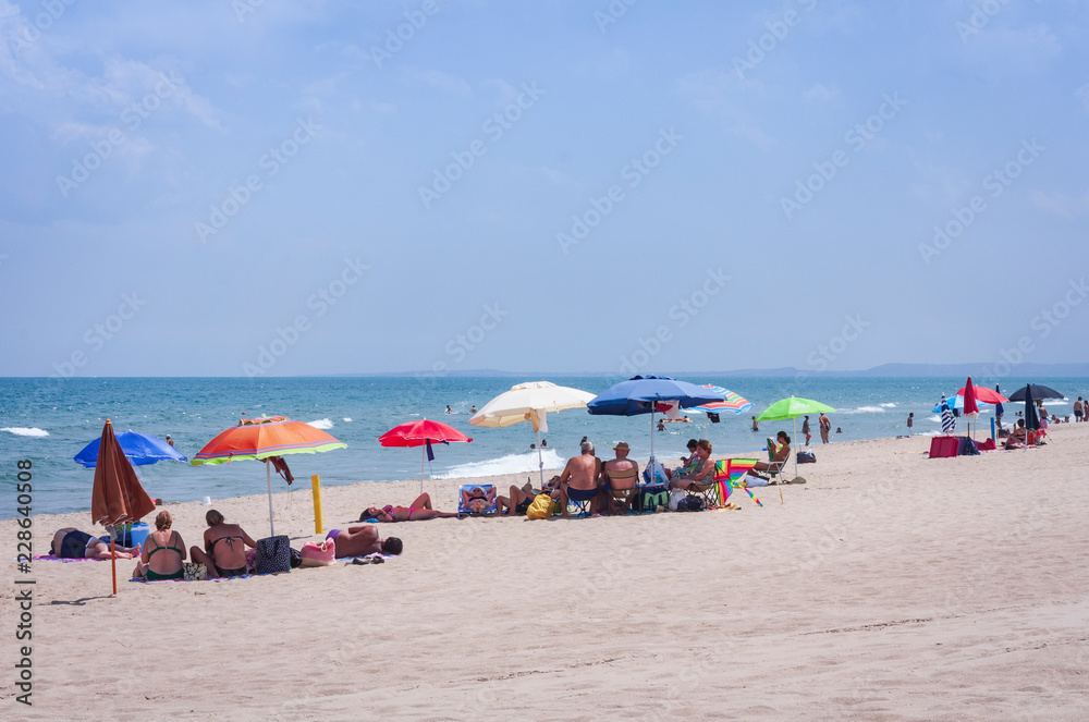 Catania, Sicily, Italy – august 15, 2018: people relax on the beach Lido azzurro Catania, Sicily, Italy – august 15, 2018: people relax on the beach Lido azzurro