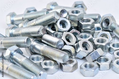 Fasteners on a white background. Manufacture of metal products.