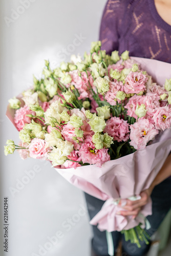 beautiful spring bouquet. Young girl holding a flowers arrangement with lisianthus of pink colors