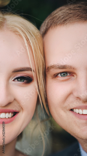 Beautiful newlyweds are smiling close up. Wedding idea. Wedding faces. Wedding photography. Half face.