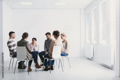 Group psychotherapy in white interior photo