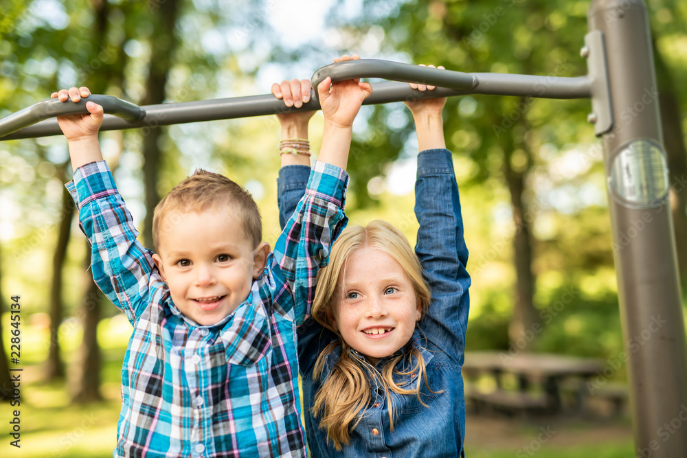 The Two young children having fun on the playground The Two young children having fun on the playground
