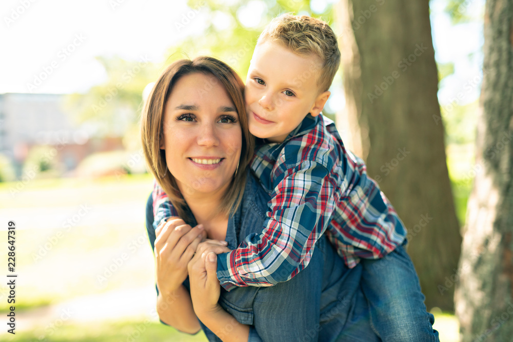Fototapeta premium happy family mother and child son playing on autumn park