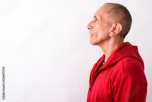 Close up profile view of bald senior man against white backgroun