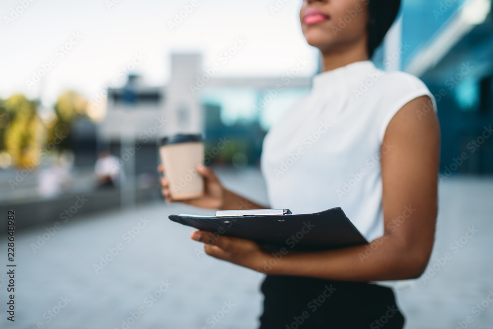 Female business person with coffee cup and notepad Female business person with coffee cup and notepad
