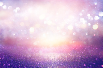 glitter vintage lights background. silver, purple and light gold de-focused.