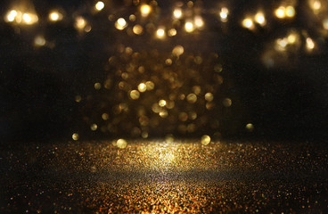 glitter vintage lights background. black and gold. de-focused