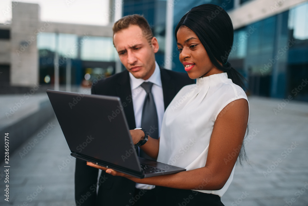 Business woman and businessman looks on laptop Business woman and businessman looks on laptop