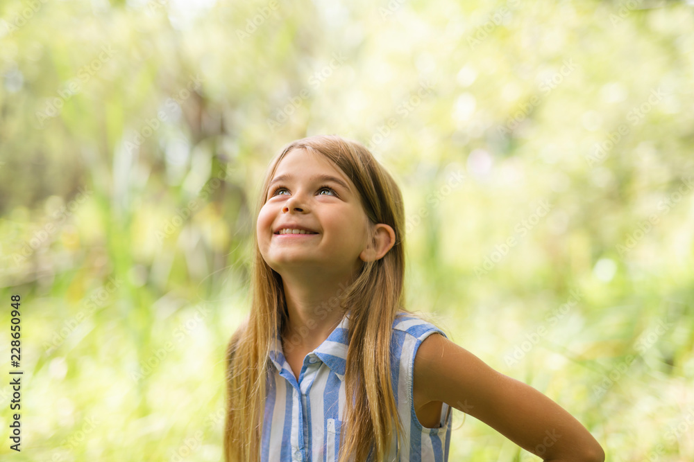 Portrait of a happy young girl outdoors forest