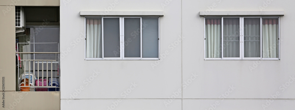 Windows on the outside of a apartment with small balcony.