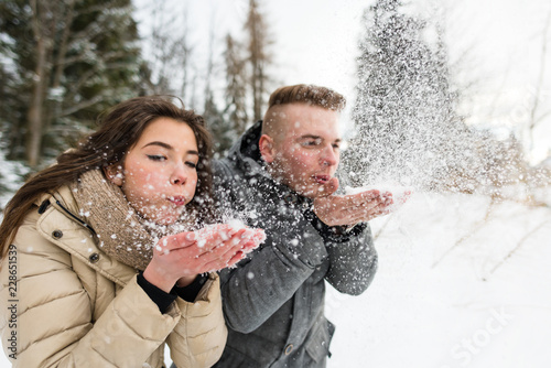 Teen couple blowing snow photo