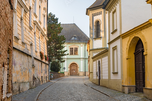 Cobblestone street cityscape with baroque and dilapidated buildings in the old town of Olomouc, Czech Republic.  © Bence