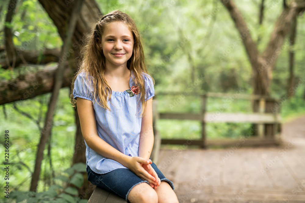 Portrait of a happy young girl outdoors forest