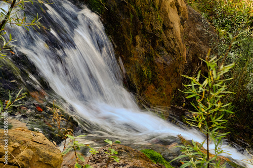  long exposition of a waterfall in th forest, Posina, Italy, October 2018 photo