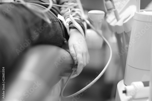 Patient's hand of a dental clinic with a clip of connected monitoring equipment