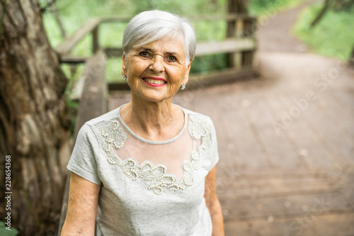 Senior woman in the nice forest park