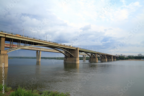 Supports of the automobile bridge across the river Ob in the summer warm evening in Novosibirsk