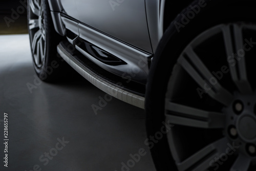 close up view of black automobile as background