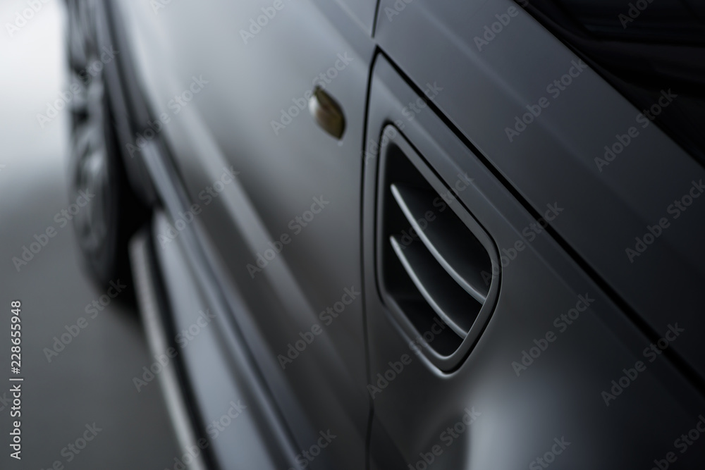 close up view luxury shining black automobile