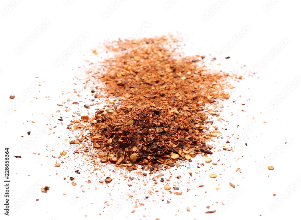Crushed, ground red cayenne pepper, dried chili flakes and seeds isolated on white background Crushed, ground red cayenne pepper, dried chili flakes and seeds isolated on white background