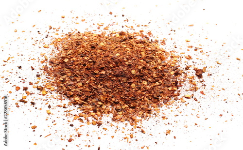 Crushed, ground red cayenne pepper, dried chili flakes and seeds isolated on white background