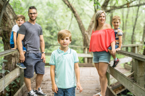 happy young family in forest having fun together