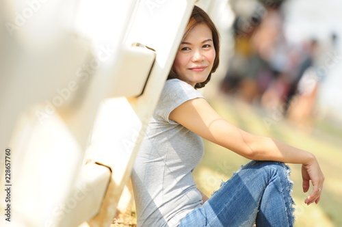 Asian girl smiling and feeling happy in the park in a sunny summer day, Have a beautiful day and happy concept. Free Download Asian girl smiling and feeling happy in the park in a sunny summer day, Have a beautiful day and happy concept. - GFXLoad