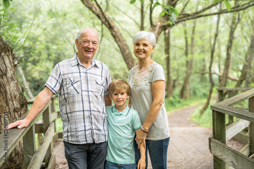 Grandparents with grandkid on summer forest having great time © Louis-Photo