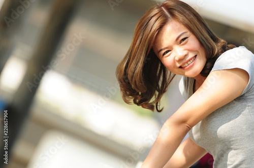 Asian girl smiling and feeling happy in the park in a sunny summer day, Have a beautiful day and happy concept. Free Download Asian girl smiling and feeling happy in the park in a sunny summer day, Have a beautiful day and happy concept. - GFXLoad