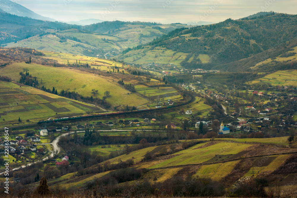 village in the valley. bird eye view. rail road and viaduct in the distance. mysterious autumn weather village in the valley. bird eye view. rail road and viaduct in the distance. mysterious autumn weather