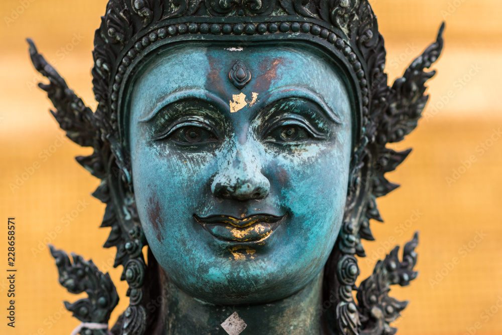 The face of a statue, a part of the Golden Mount compound that belongs to an ancient Buddhist temple Wat Saket, Bangkok