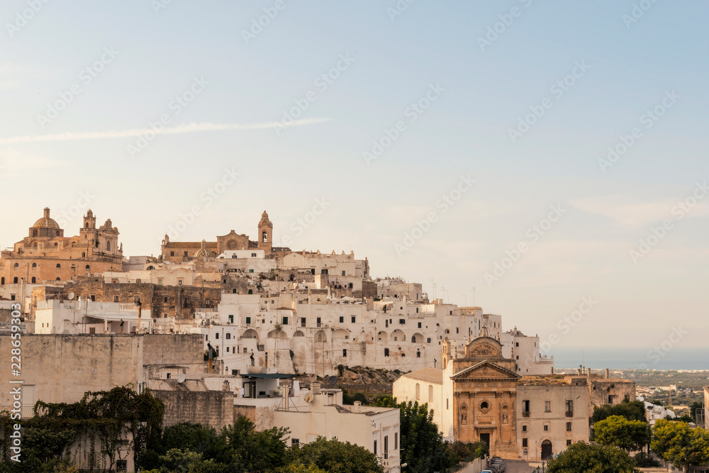 Obraz premium Panoramic view of the medieval white village of Ostuni at sunset