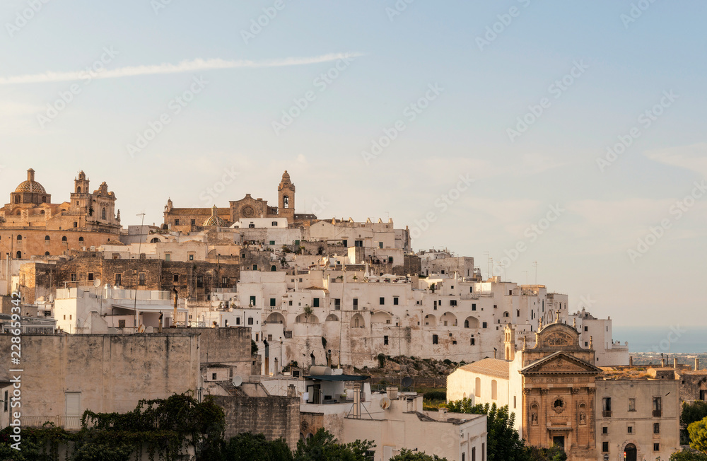 Panoramic view of the medieval white village of Ostuni at sunset
