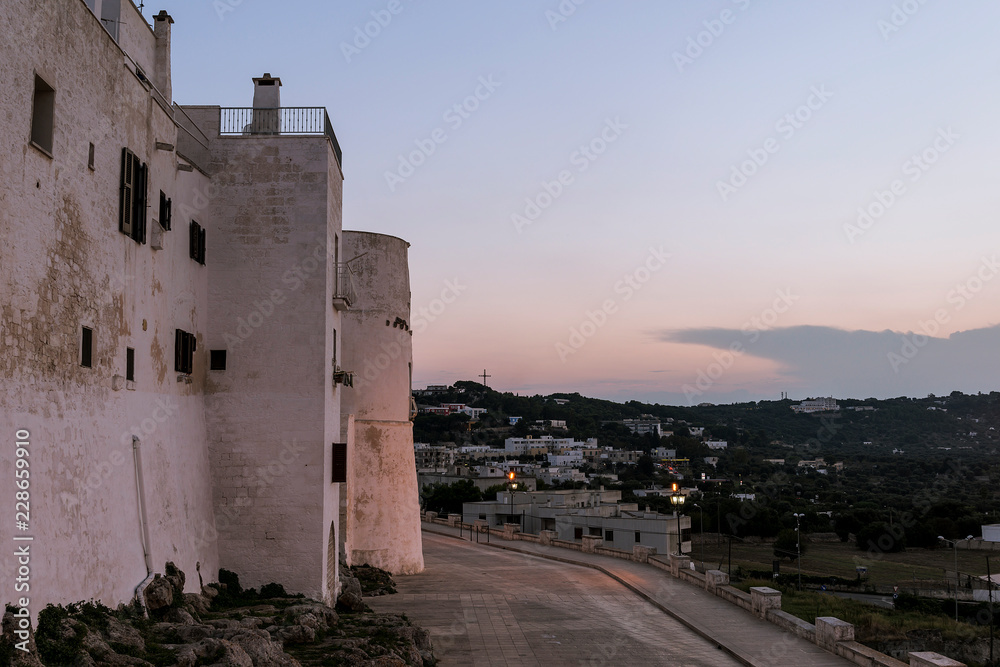 Walls of the medieval white village of Ostuni at sunset
