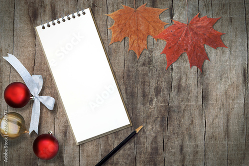 Blank Paper Note Book  Pencil and Autumn Leaves on Wooden Background with Copy Space  Season s Greetings Concept