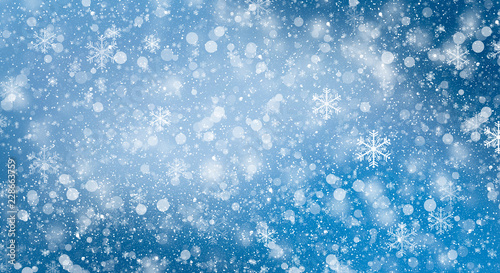 Blue bokeh background with snowflakes. Empty winter background, snowy, celebratory. © MiaStendal