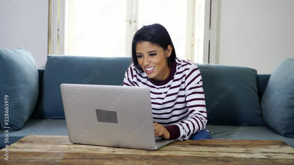 Attractive young latin woman holding credit card and using laptop computer buying on the internet at home in shopping online business and technology digital marketing casual lifestyle concept. Attractive young latin woman holding credit card and using laptop computer buying on the internet at home in shopping online business and technology digital marketing casual lifestyle concept.