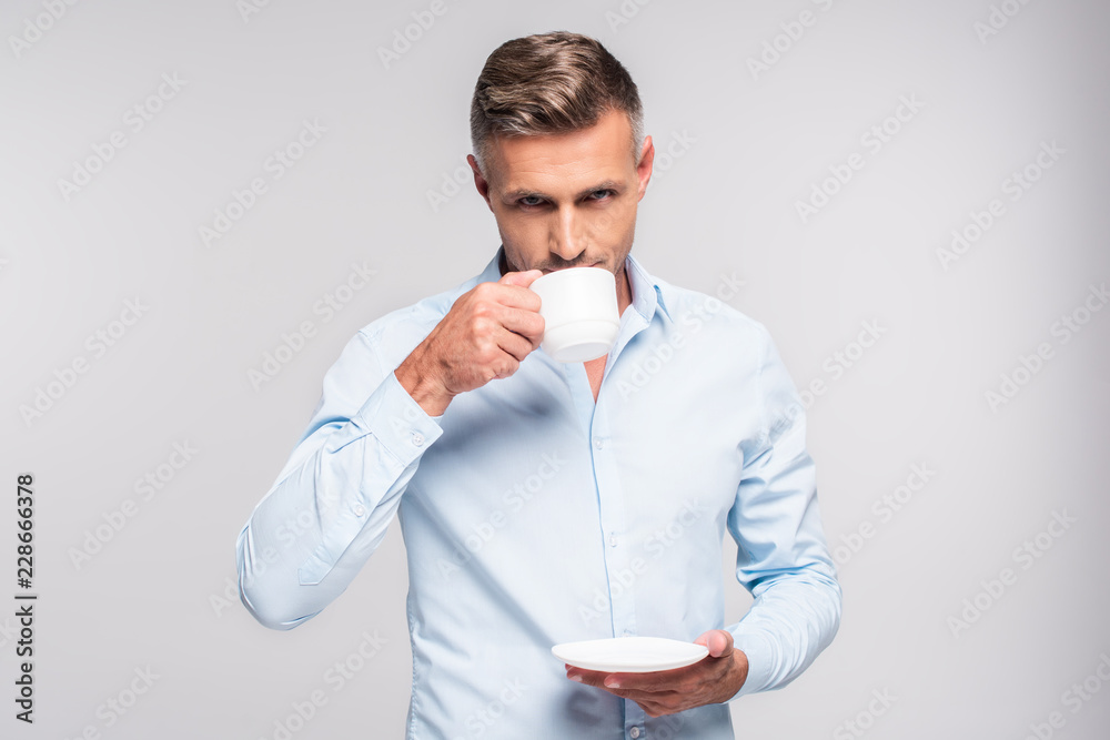 handsome adult man drinking coffee isolated on white handsome adult man drinking coffee isolated on white