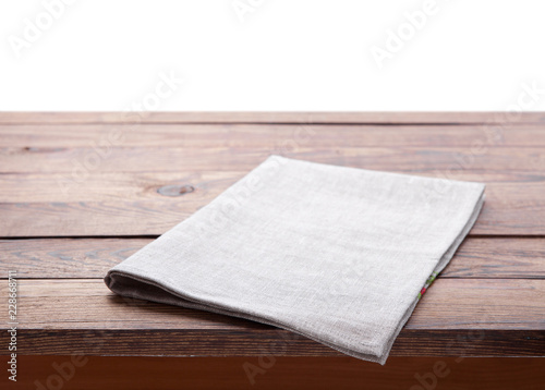 Table with white napkin isolated on white.