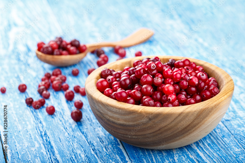 raw cranberries in a wooden plate raw cranberries in a wooden plate