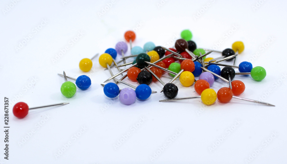  Various colored pins on white background