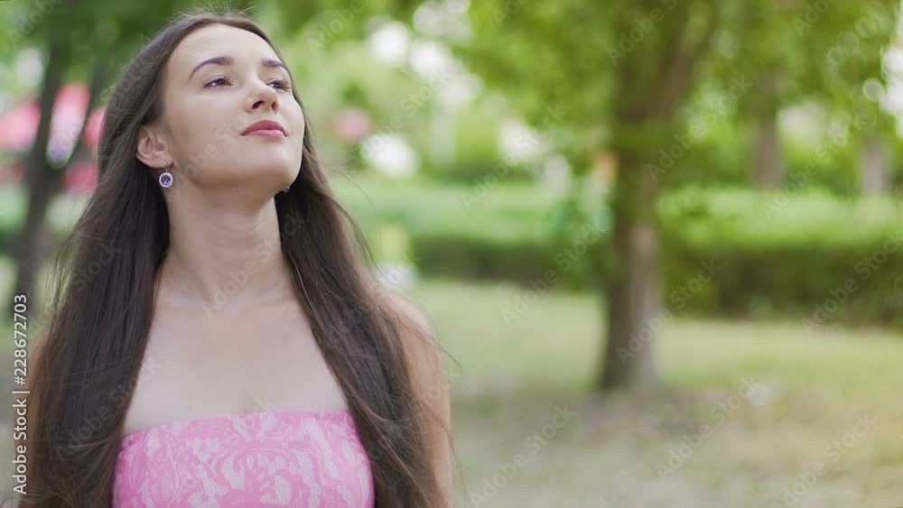 Beautiful lady smiles and looks up to sky, joy of living, pleasure of existence Beautiful lady smiles and looks up to sky, joy of living, pleasure of existence
